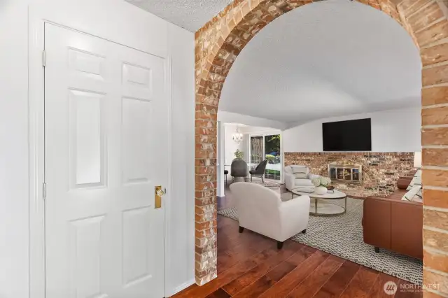 Photo Virtually Staged - Step into a freshly painted interior with a convenient coat closet and classic brick arch.