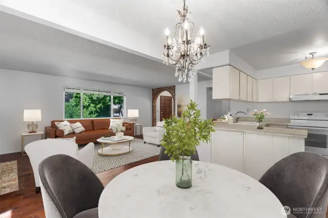 Virtually Staged Photo - Large windows in the living room and the glass slider off of the dining nook keep the home bright and offer nice views of the greenery outside.