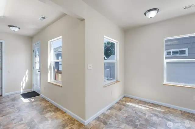 Dining area with vinyl floors and tons of natural light.