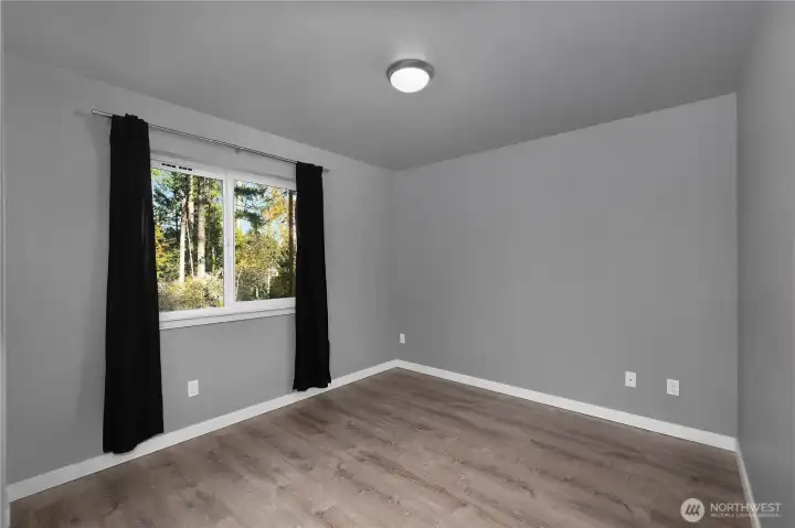Bedroom 2 looks to the front yard - fresh with sod and beauty bark.