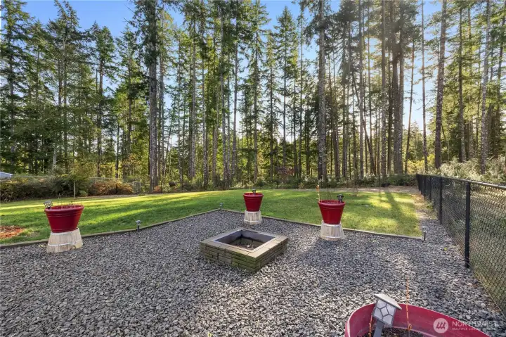 Firepit in fully fenced backyard.