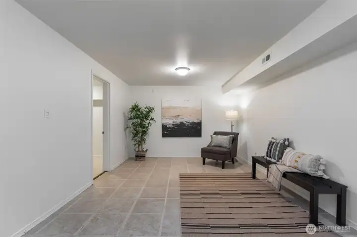 This lower level space is great for storage. The walls can be lined with built-in's or shelves and there would still be room for more.