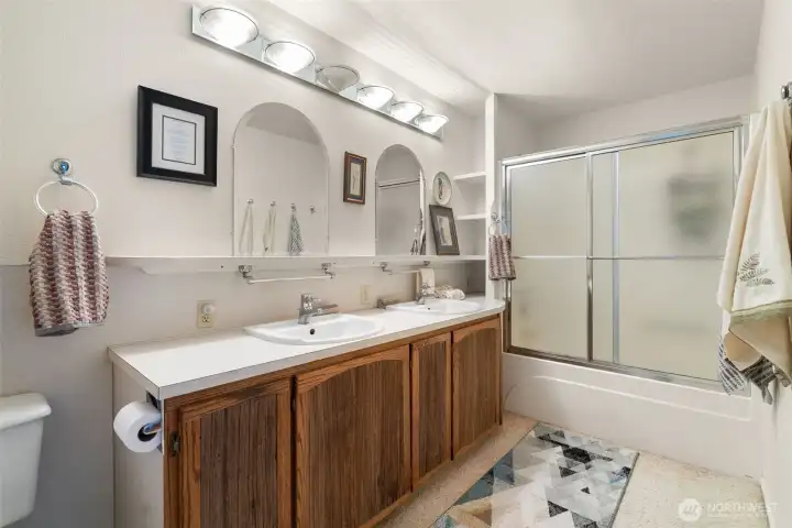The ensuite bathroom includes a tub/shower combination and double sinks.