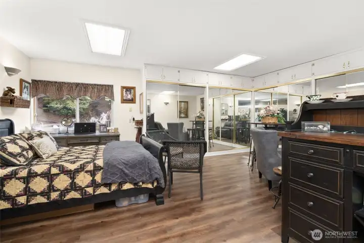 Expansive private guest suite offering a full wall of closets and generous space for a relaxing sitting area—perfect for guests’ extended stays or a second primary bedroom