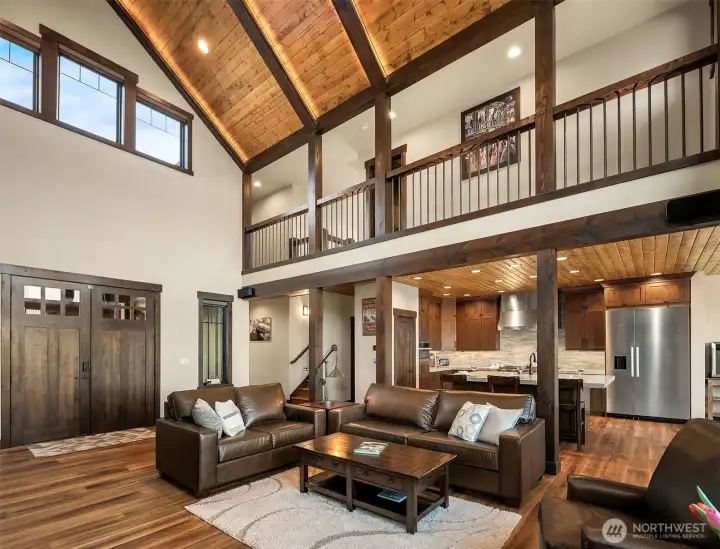 Living room facing kitchen and upstairs hallway