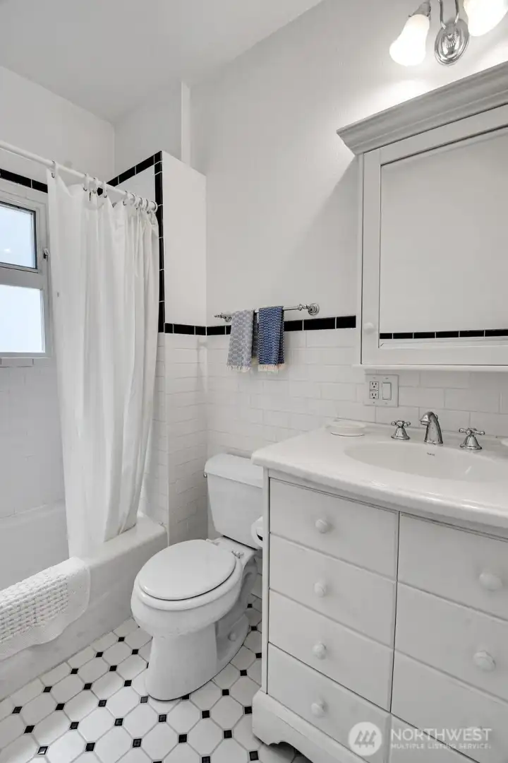A full bathroom with tile accents sits between the main level bedrooms