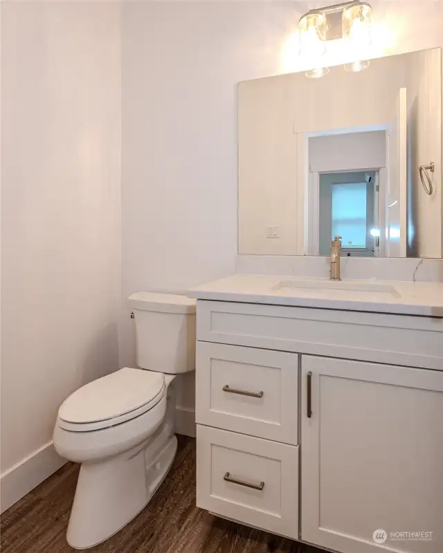 The convenient main floor Half Bathroom features an attractive vanity with quartz counter.