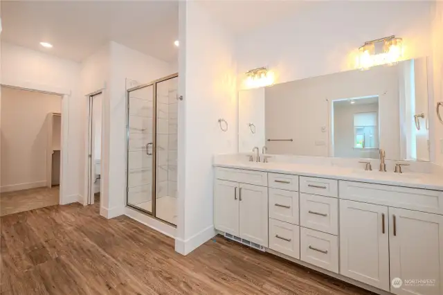 Prepare to be captivated by the dreamy Primary Bathroom! Revel in the expansive mirror, dual sink vanity boasting fabulous storage and stunning quartz counters. The touch of a dial directs warm air out from a vent below the vanity to keep your toes nice and toasty.