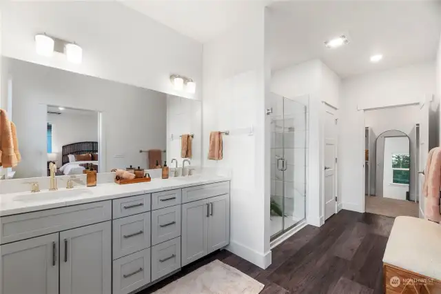 Prepare to be captivated by the dreamy Primary Bathroom! Revel in the expansive mirror, dual sink vanity boasting fabulous storage and stunning quartz counters. The touch of a dial directs warm air out from a vent below the vanity to keep your toes nice and toasty.