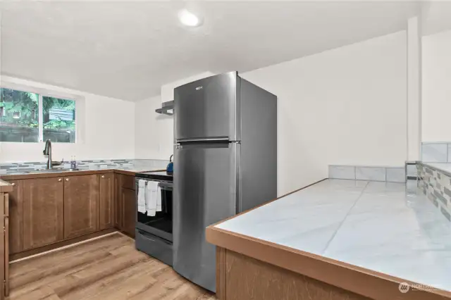 The lovely kitchen has top quality appliances and nicely appointed cabinets and counter spaces.