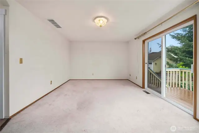 Bonus room off the kitchen has the best view! Large slider opens onto the back deck with stairs to the fully-fenced yard below.