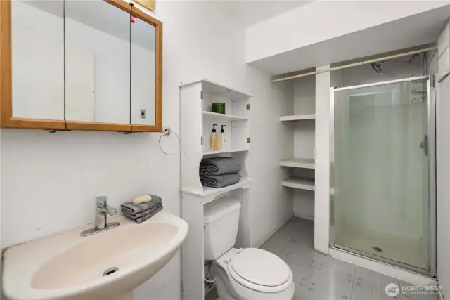 Large lower level bathroom hasn't been updated, but offers plenty of storage and potential.