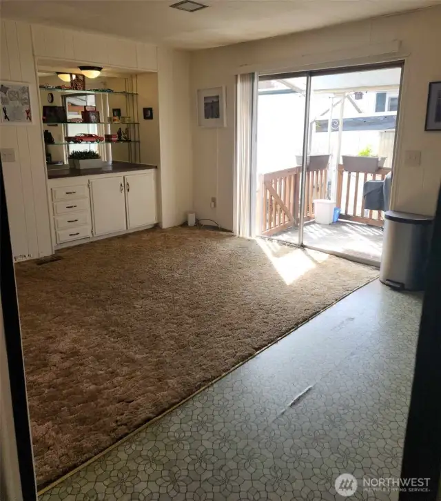 Second dining area off of kitchen, featuring another built-in and a slider to the back deck.