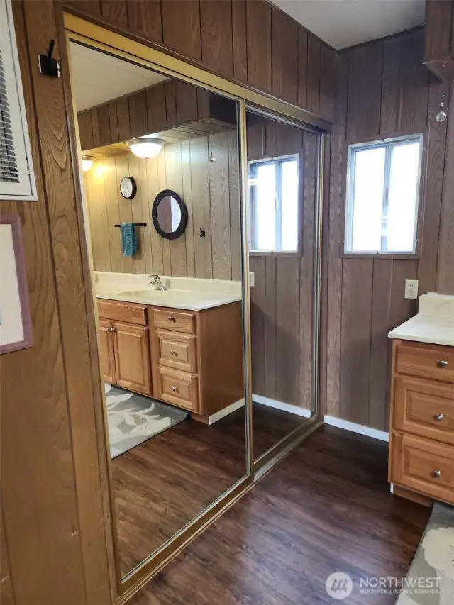 As you enter main bathroom, there is another large mirrored closet.