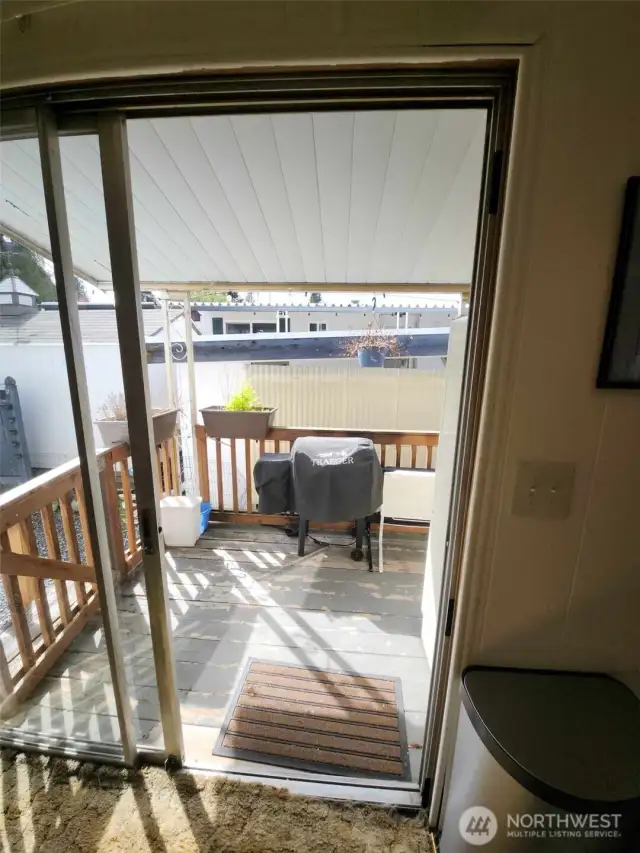 Off the kitchen eating space is the slider to the back deck with stairs to the left leading down to the side yard.