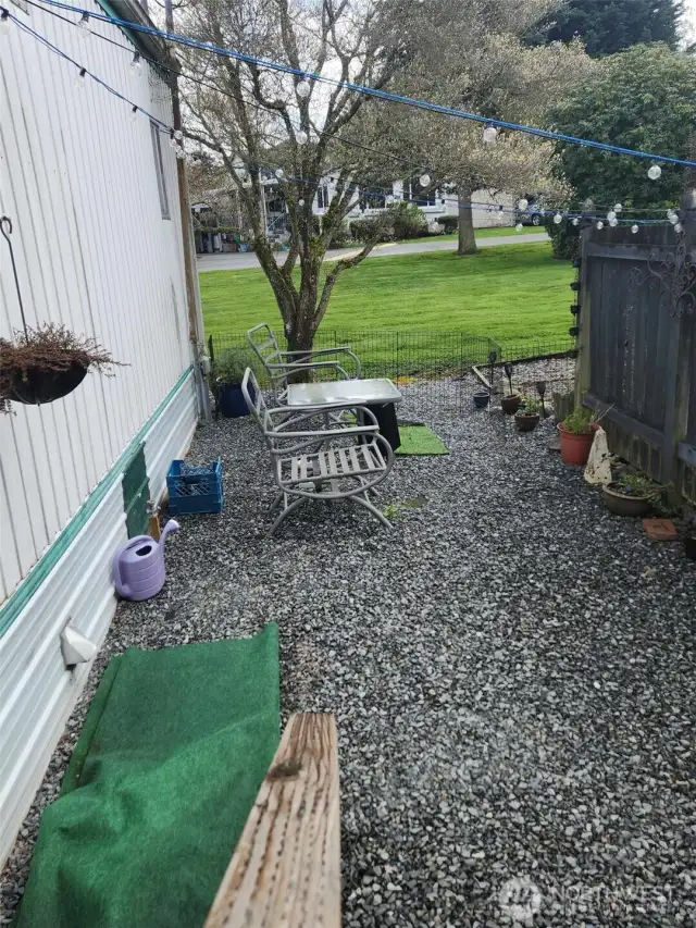 Off the deck, take the stairway down to the side yard with plenty of space for a seating area.