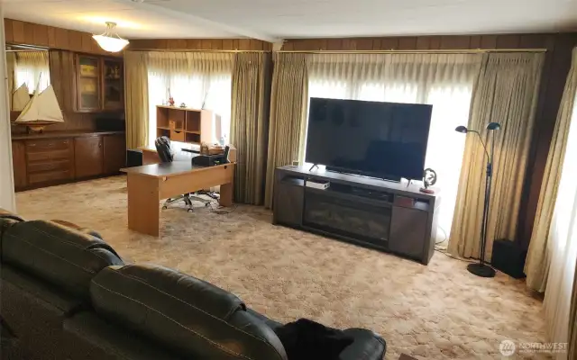 Living/great room rounds into the formal dining area featuring a built-in.