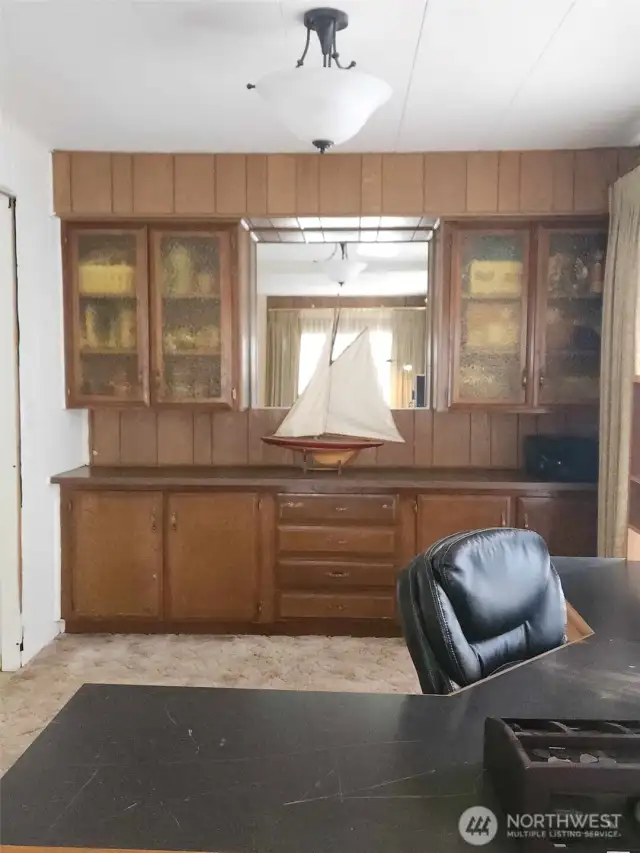 Plenty of storage throughout this home, including generous built-ins. To the left of this dining room is the galley kitchen.