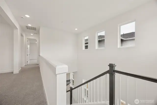 Top of stairs overlooking 2 story entry with 6 light windows