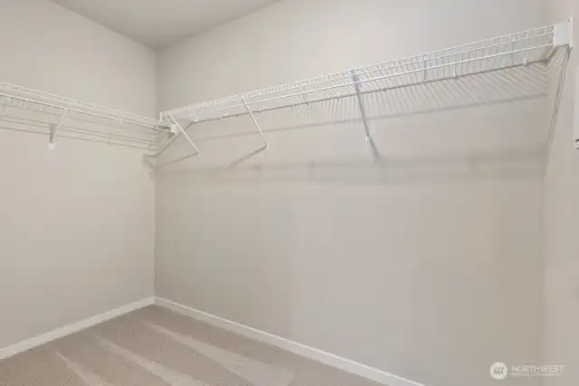 Primary walk-in closet; Colors, finishes, and options will vary.