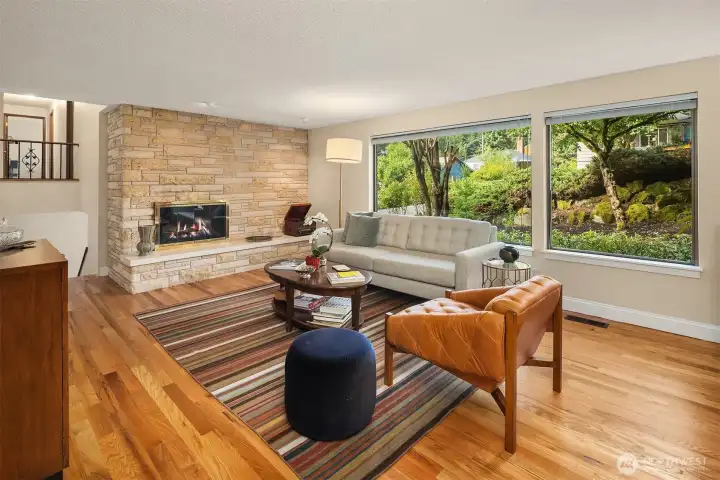 Large windows blend inside with the greenery of the front yard