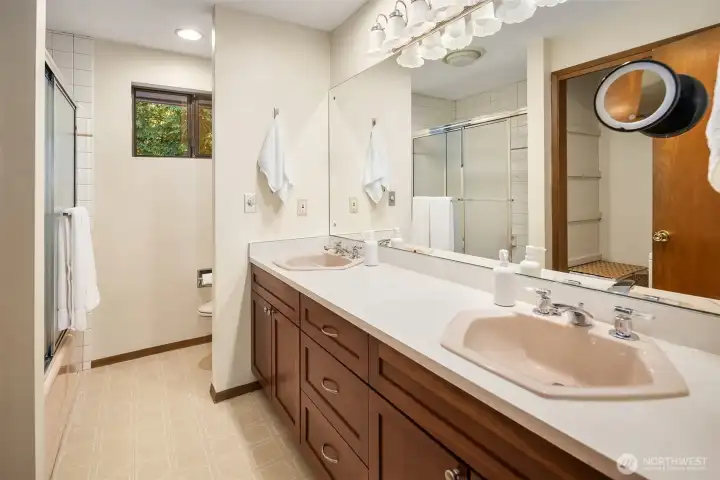 This spacious bathroom serves the secondary rooms and even has a stacked laundry unit in the closet!