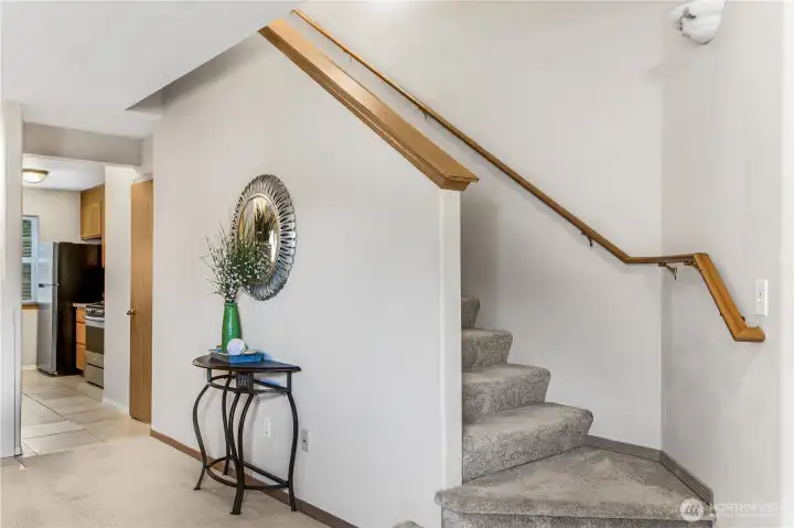 Looking from living area into kitchen and stairway to bedrooms.