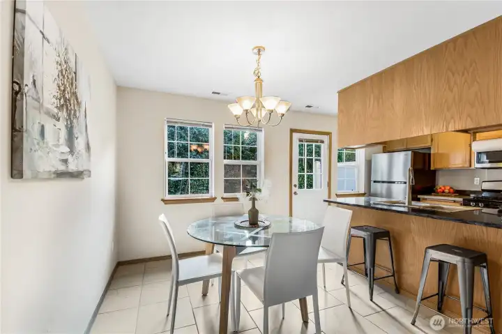 Dining room off of kitchen area with additional seating at counter.