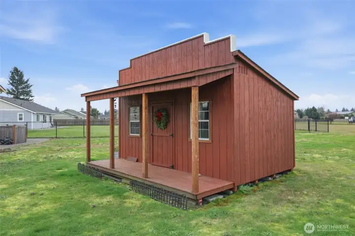 Western style Garden Shed houses the riding mower & garden tools. (Ramped in back)