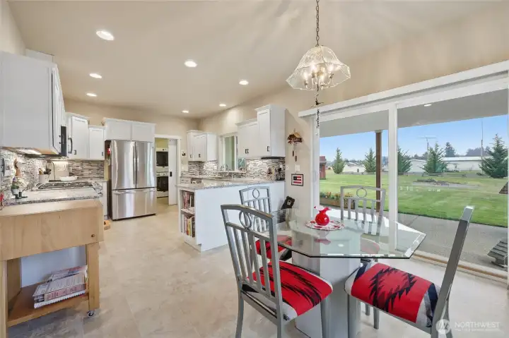 Open kitchen space with a lovely view of the backyard.  Granite countertops, stainless steel appliances, modern features & practical design.