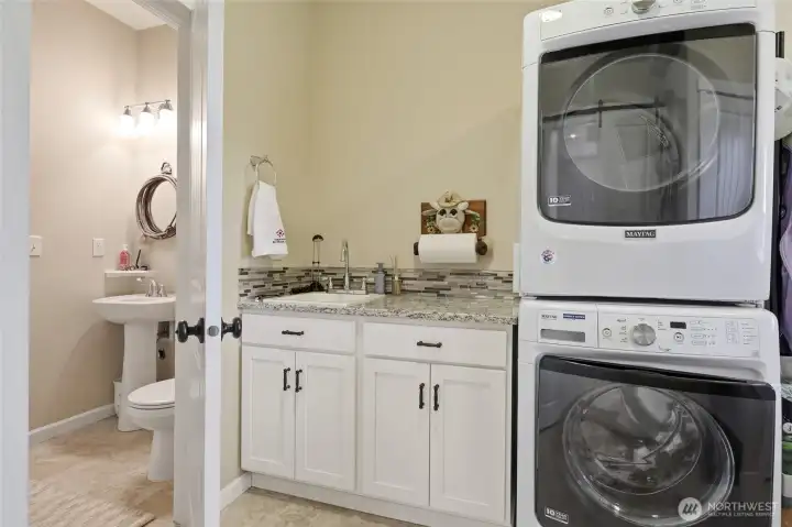 Utility Room- Stacked front loading washer & dryer stays!