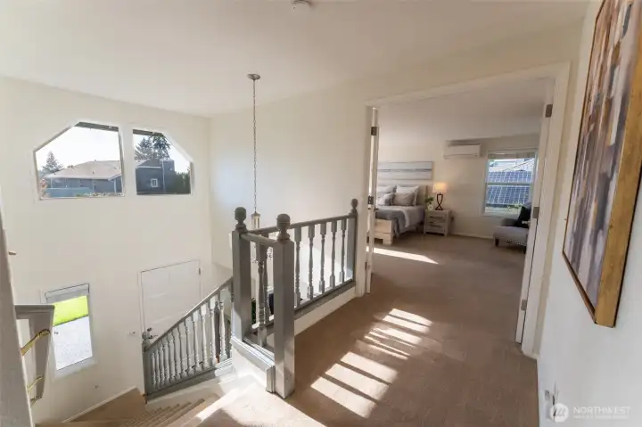 Upstairs landing looking toward Primary Bedroom and front door