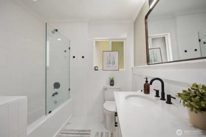 Beautiful tile floor to ceiling, porcelain floors, and quartz countertops