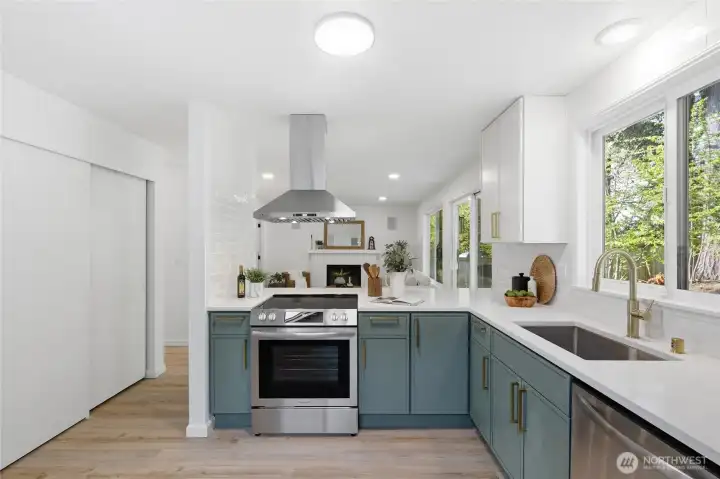 The L-shaped kitchen layout maximizes workspace and storage, with quartz counters, a deep stainless sink, and a slider leading to the backyard — bright and open throughout.