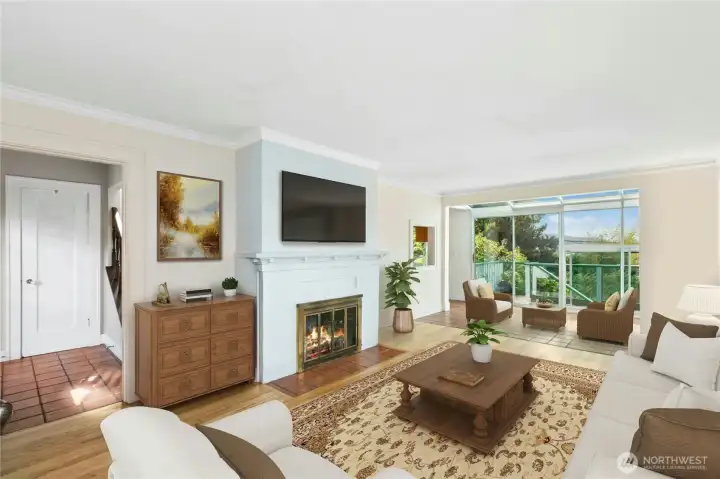 Large living room with atrium views and gas fireplace.