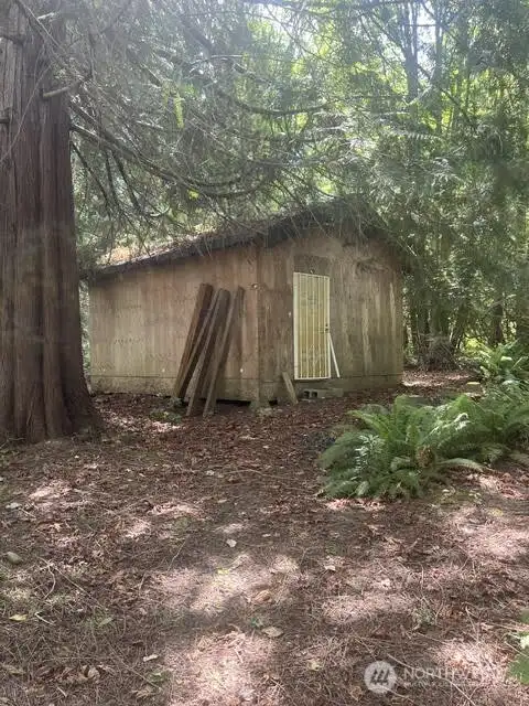 At the back of the lot is a large shed for storage.