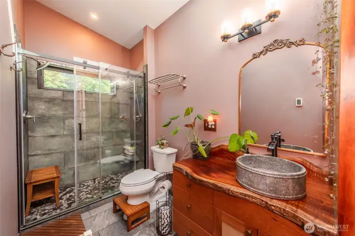 The primary bath, a custom two-headed shower and heated floors turn daily routines into something a little more considered. The primary bath, a custom two-headed shower and heated floors turn daily routines into something a little more considered.
