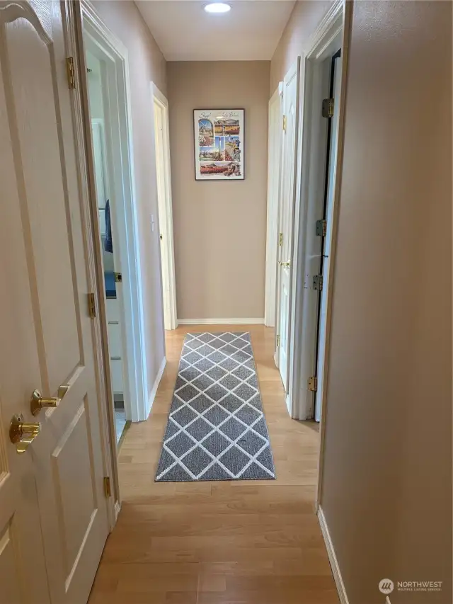 On the left here is where the natural gas furnace and water heater are located along with some more storage areas. The guest full bath is on the left, bedrooms Uno & Dos are on the right with the owner’s suite on the far left.