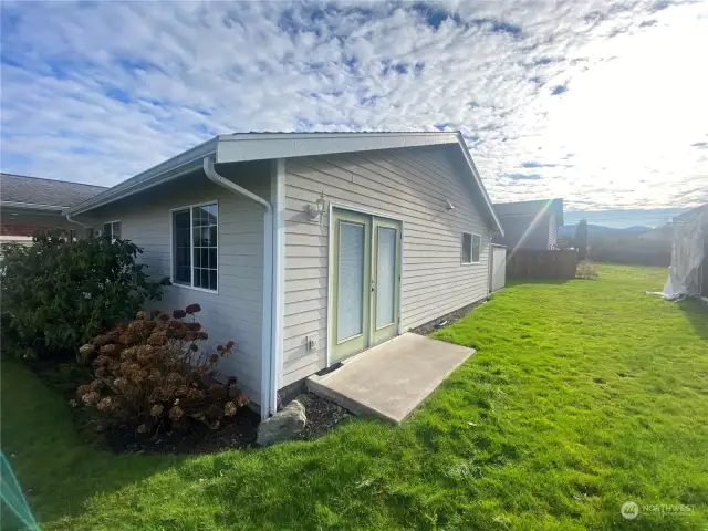 Quaint patio off this north westerly bedroom.  If you need to someday use a wheel chair, this entry couldbe made a feasible option with little modification by addition a pathway to the front or back.