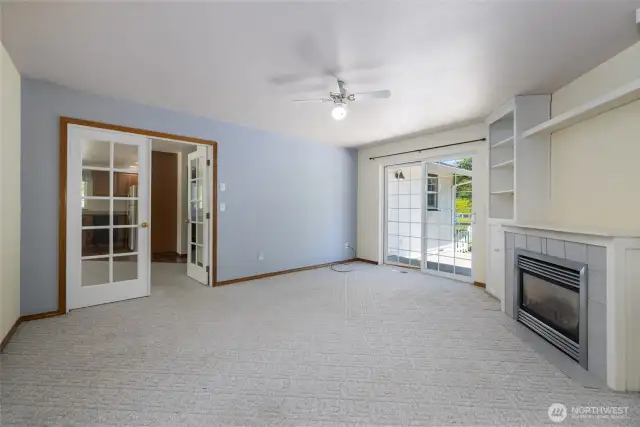 ADU Family Room with French Doors to Living Room & Kitchen area.  Gas fireplace for those cool days and built-in cabinets providing ample storage space. There is also a slider to the back deck.