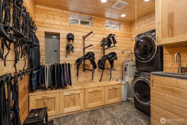 Beautiful T&G tack room with Washer and dryer, sink, saddle racks and storage
