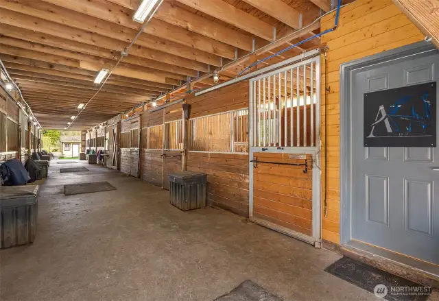 Main barn with 14 stalls, powder room, 2 tack rooms, matted paddocks off each stall.