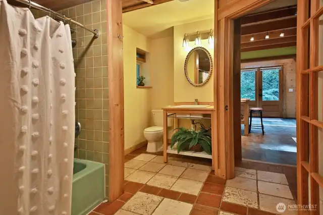 Full bath with ceramic tiled floor. Washer & Dryer are to your right, just beyond the right edge of this photo. Walk- in-closet is to your back.