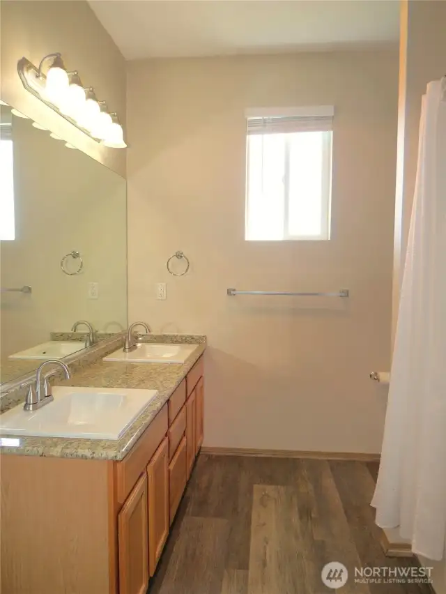 THE FULL BATH  WITH SHOWER/ TUB COMBINATION IS SHARED WITH THE LIVING AREA AND CONTINUES WITH PLANK VINYL FLOORING!