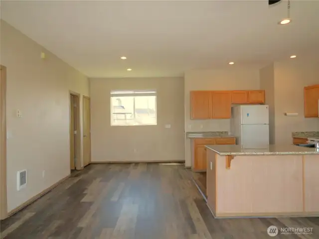 THE DINING ROOM IS CLOSE BY AND CONTINUES WITH THE VINYL PLANK FLOORING!