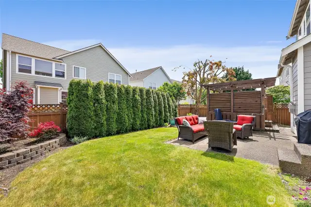Fully fenced with privacy bushes; gazebo removed