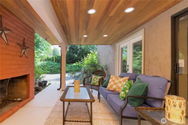 Covered patio with an outdoor fireplace