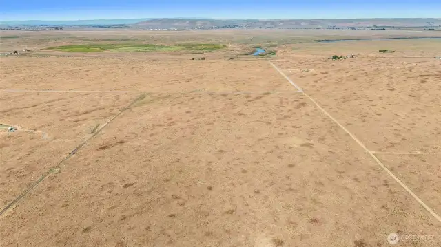 Access is from Road 16 and Road C. There are gravel driveways on the north and south sides of the property, as seen here on the left and right of the photo. However, it is unknown if they are ON the property. Buyer to verify.