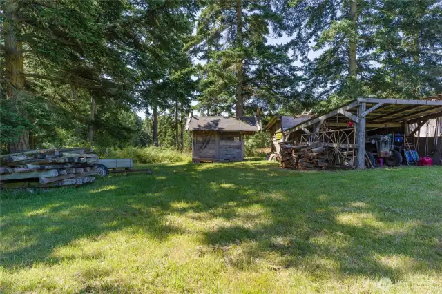 Shower building on left with tractor shed on right.  Outhouse is just behind the tractor shed.