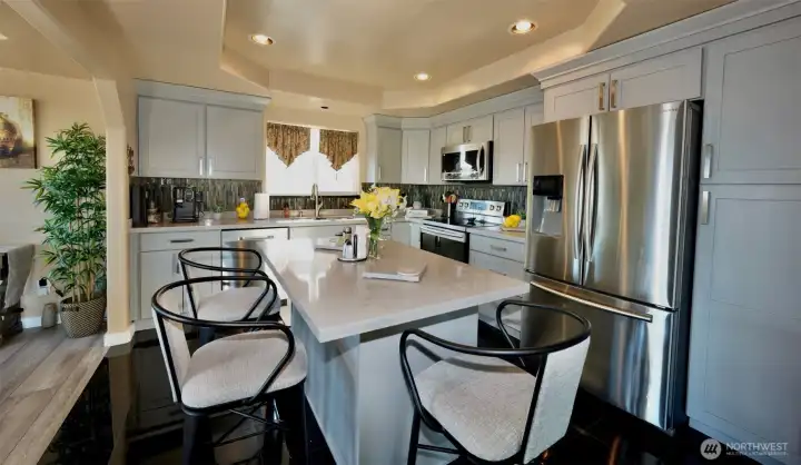 Remodeled kitchen with eating island and quartz countertop